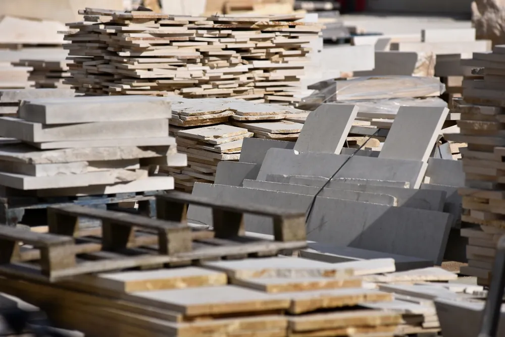 CNC machine cutting a stone slab in a fabrication shop